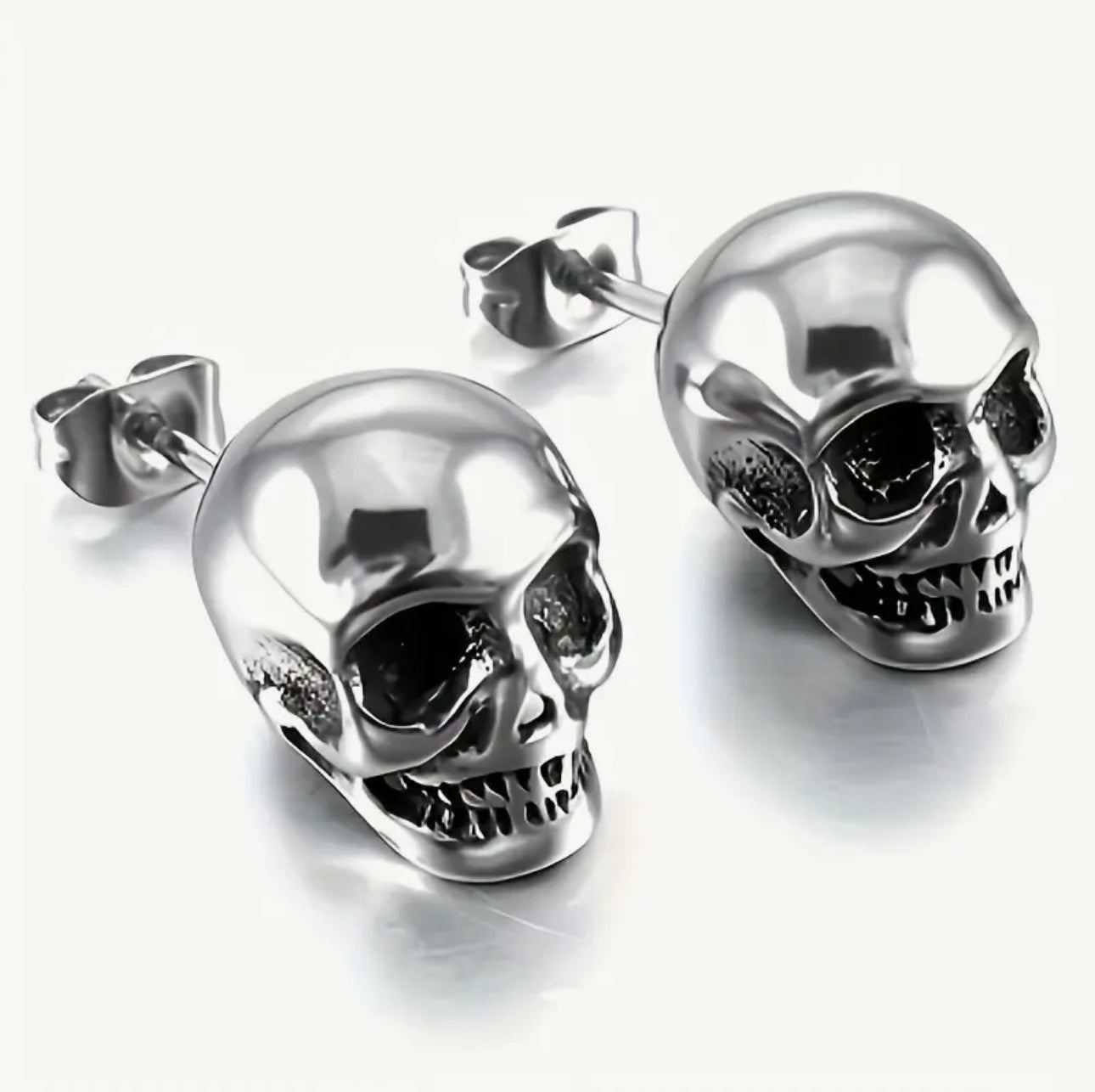 2 pairs of Skull Stud Earrings Skulls. 1 Pair Black, 1 Pair Silver. Stainless Steal Earrings. Unisex Punk Gothic Earrings.